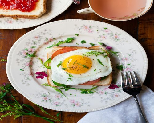 Eggs, bread, and tea prepared for breakfast